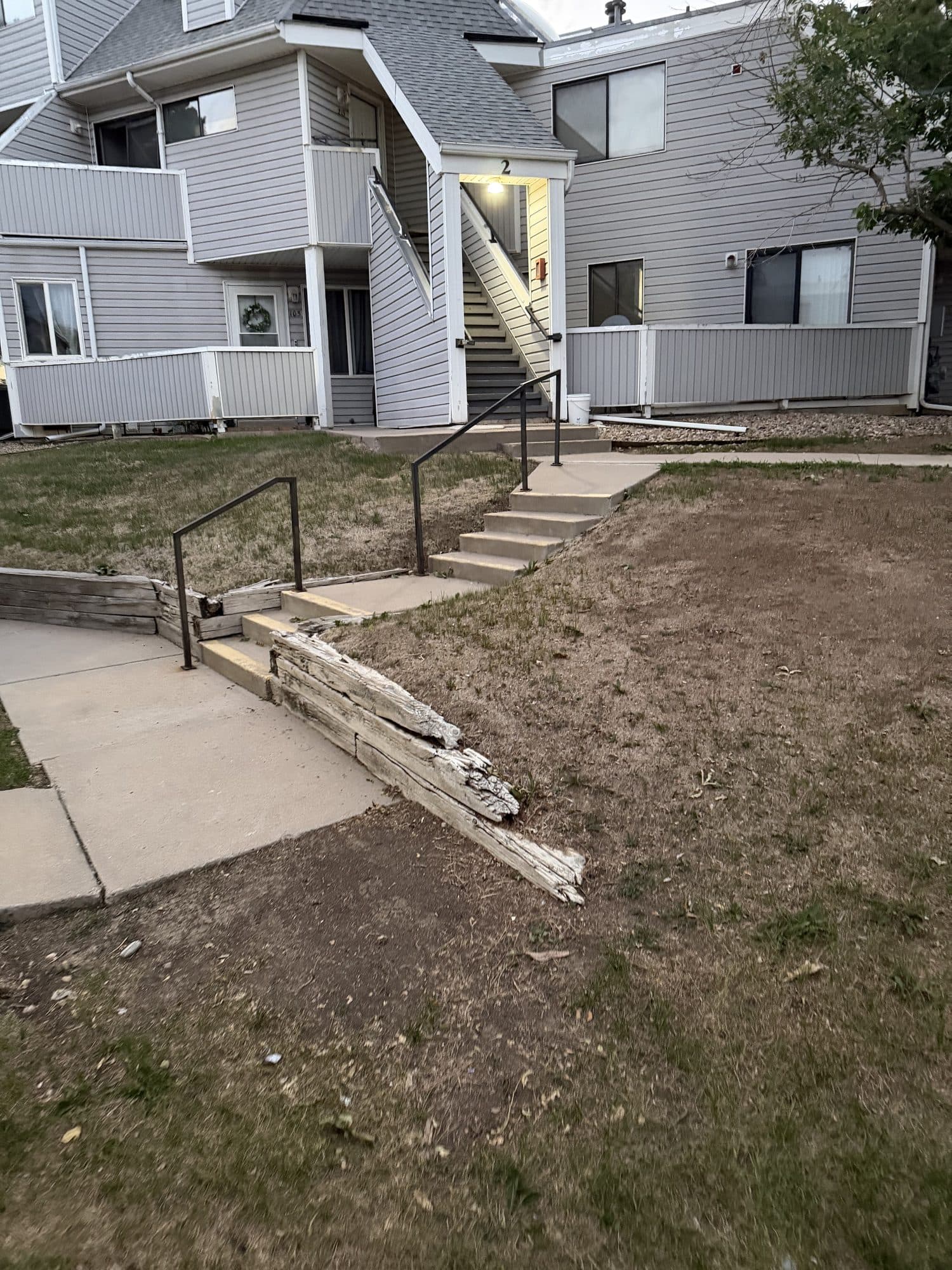 Stairways and walkways overview — IMG_1086: Multiple exterior stairways, ramps, and walkways over patchy grounds.